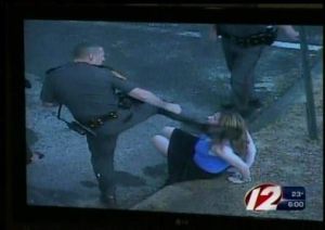 Rhode Island Police Officer Edward Krawetz kicks handcuffed woman in the head.
